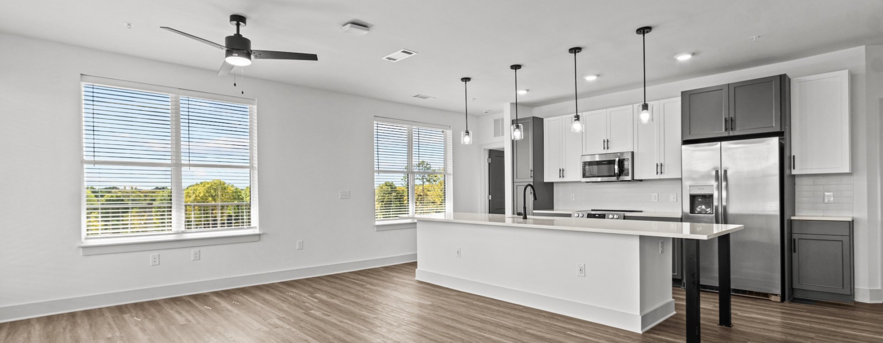 kitchen and living area with many windows