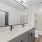 bathroom with a large mirror and double vanity