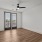 large room with a ceiling fan and doors with windows