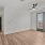 large room with a ceiling fan and doors with windows