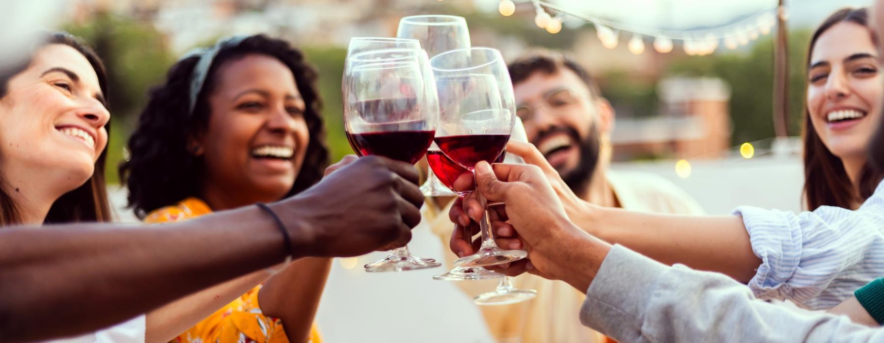 a group of people holding wine glasses